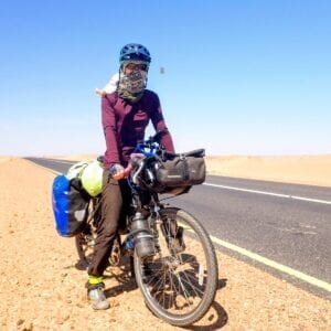 Bicyclist on desert highway in Sudan